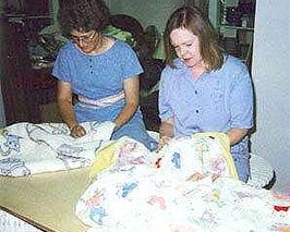 Sewist repairing quilts in the atelier