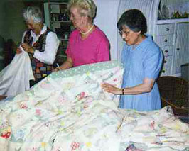 Sewist repairing quilts in the atelier