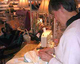 Sewist repairing quilts in the atelier